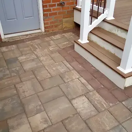 Brick and paver patio with steps and doorway.