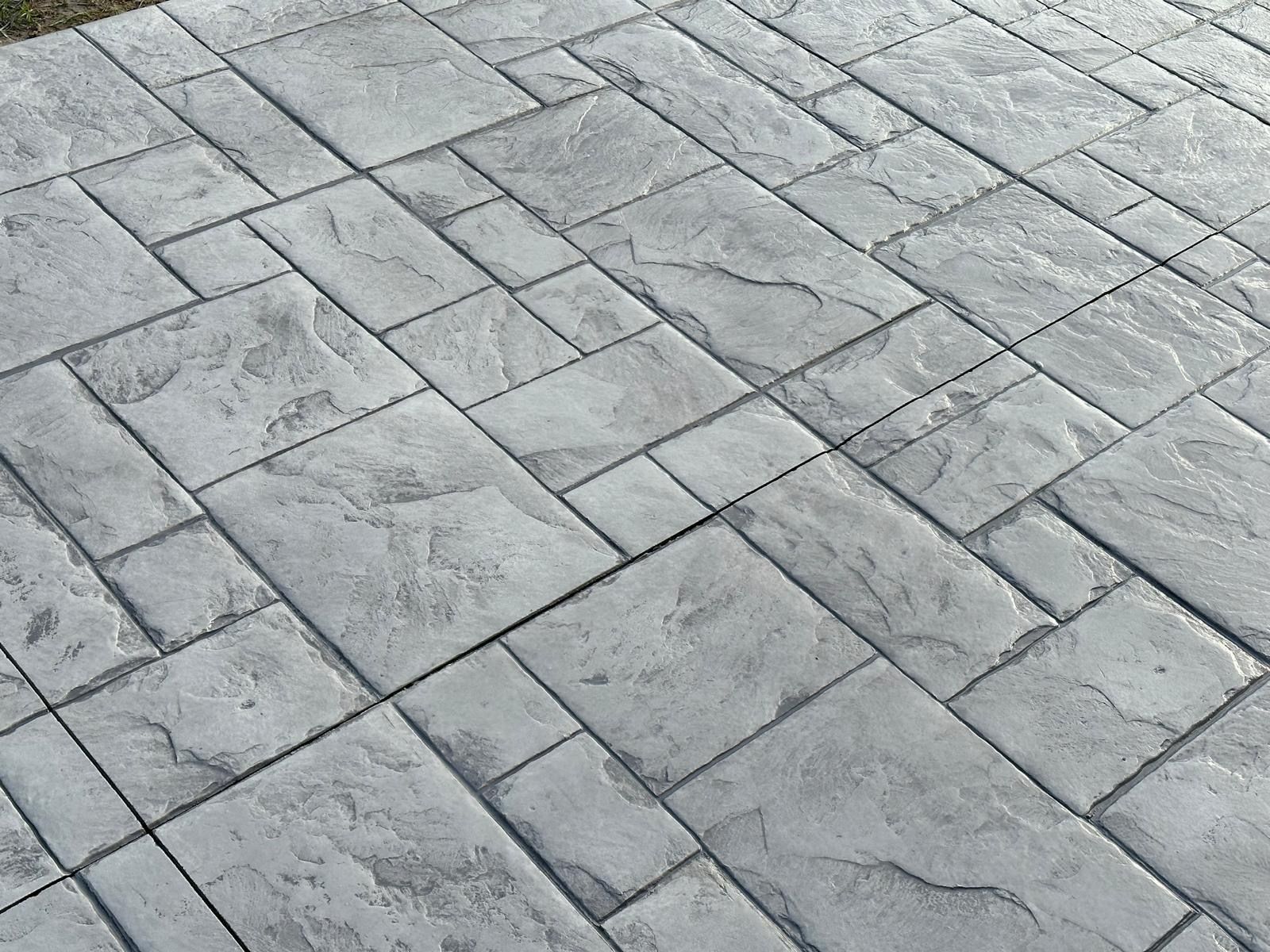 Gray stone pavement with diagonal rectangular pavers and subtle marbled texture
