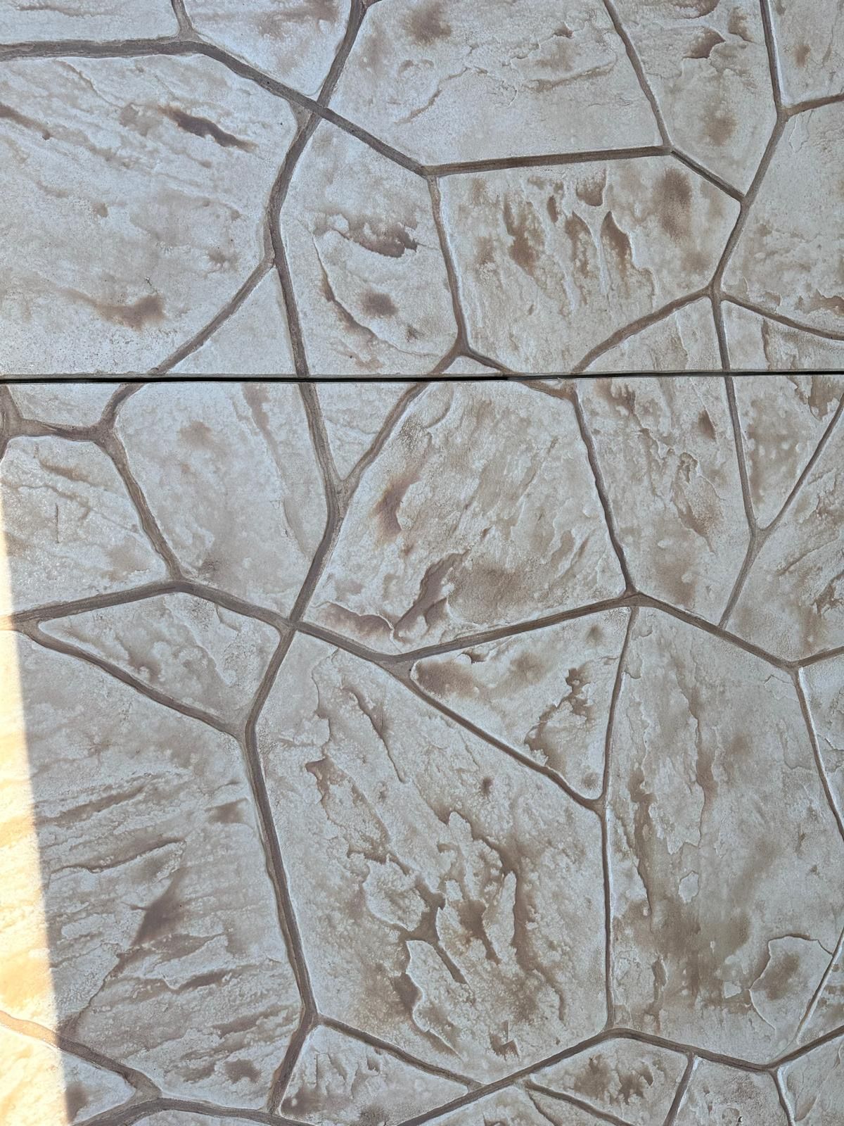 Light beige textured stone pavement with irregular polygon tile pattern