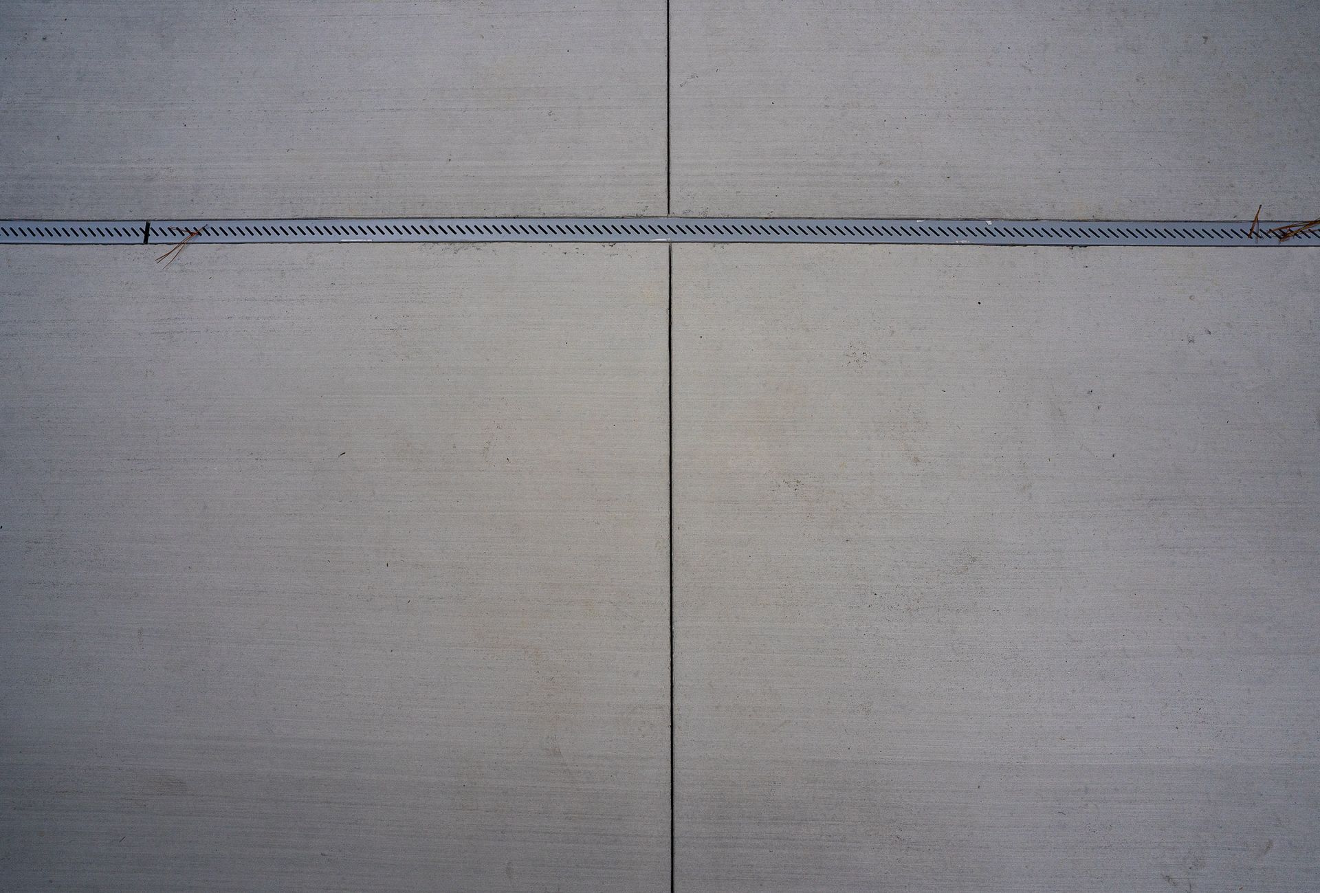 Concrete wall with a horizontal blue line near the top and a vertical seam down the center.