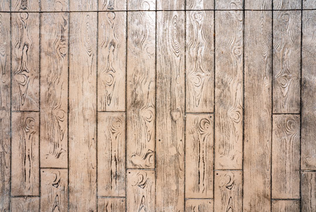 Weathered vertical wooden planks with faded white paint and knots, forming a rustic wall background