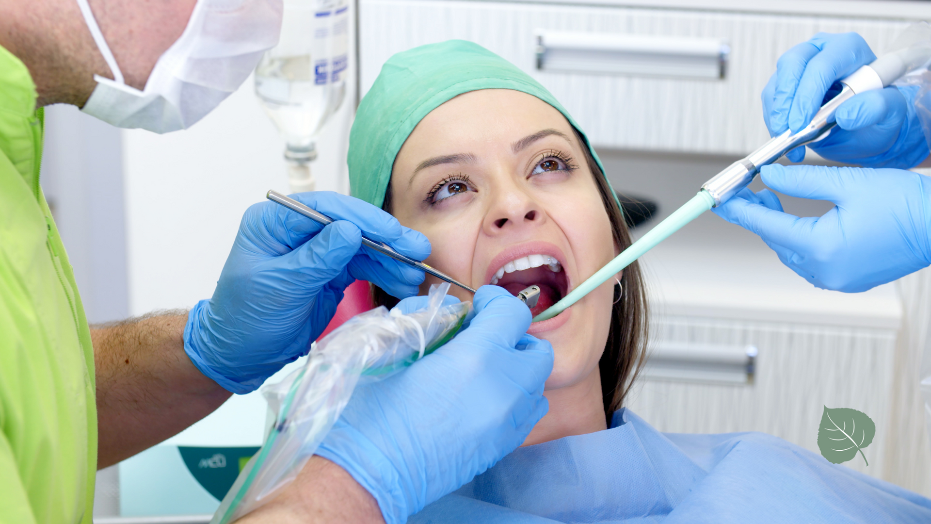 A woman is getting her teeth examined by a dentist.