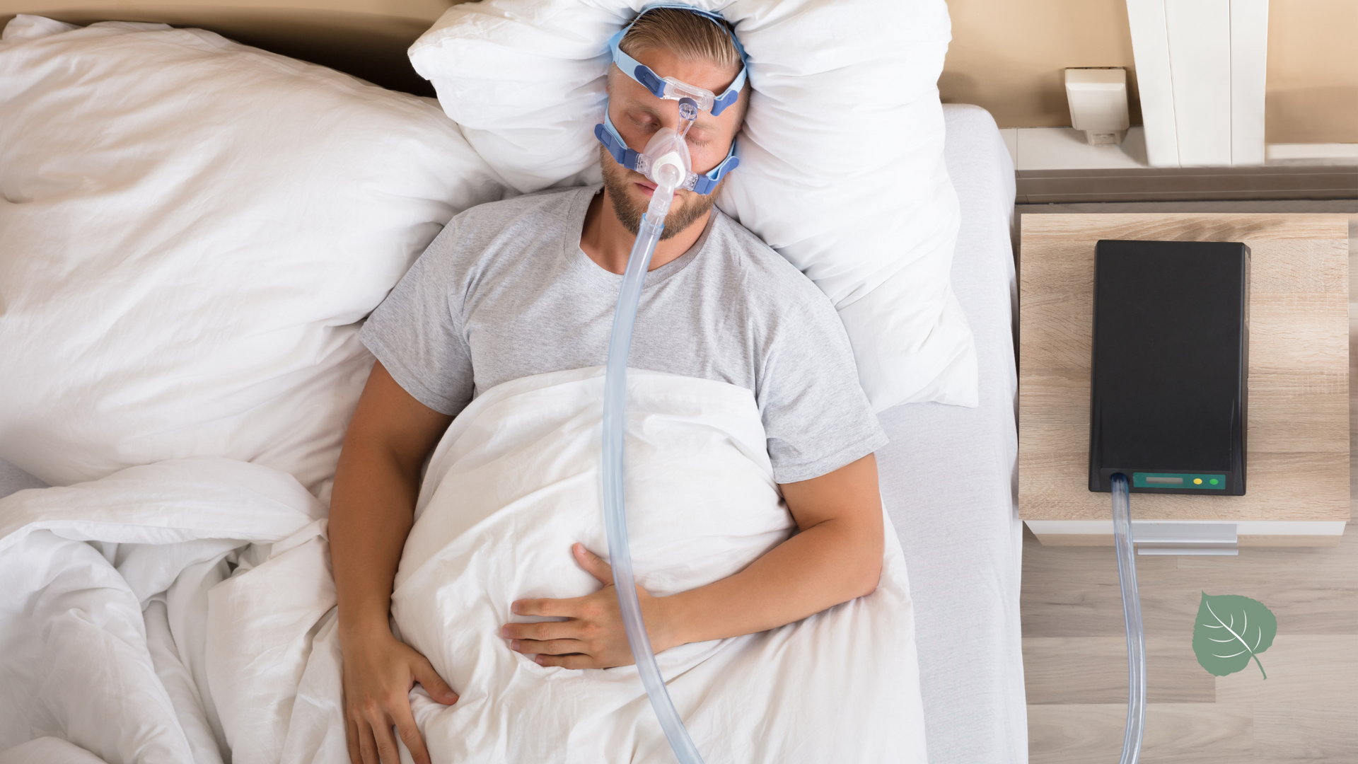 Person wearing a CPAP mask lies in bed; a machine sits on the nightstand.