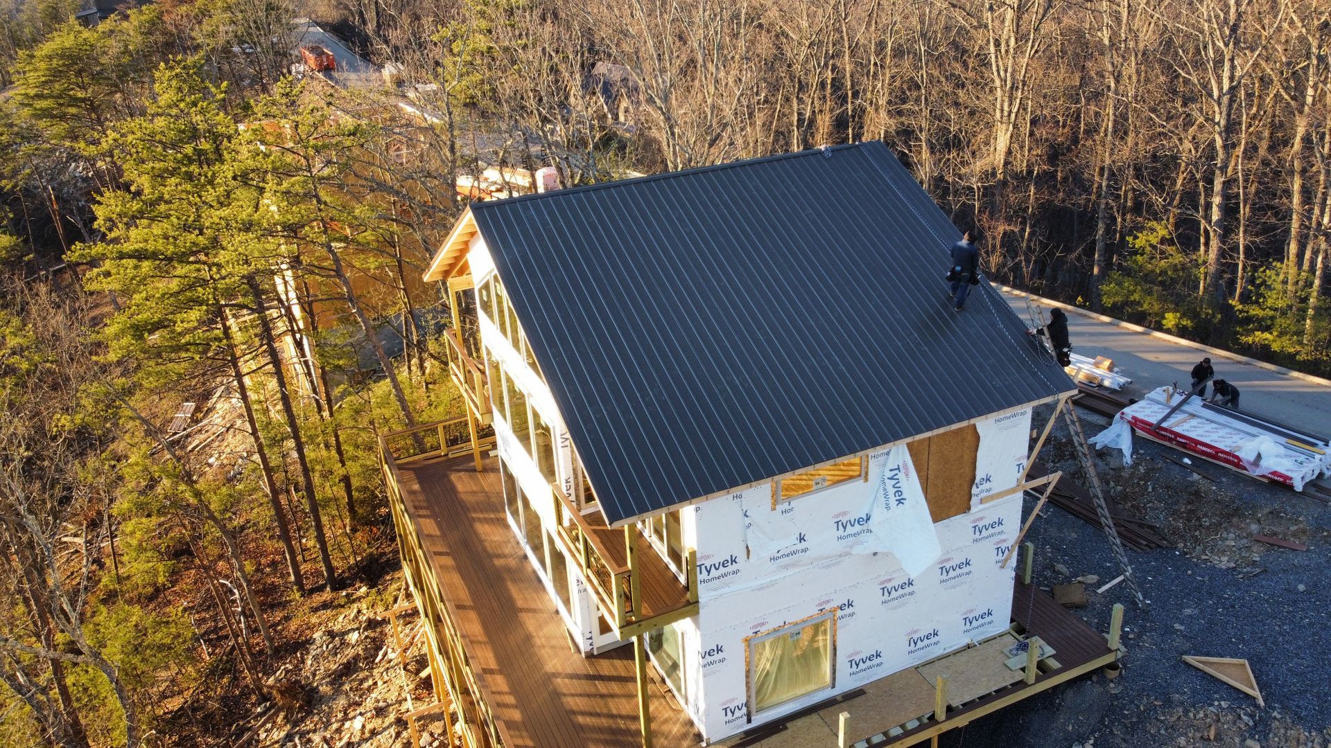An aerial view of a house under construction in the woods.