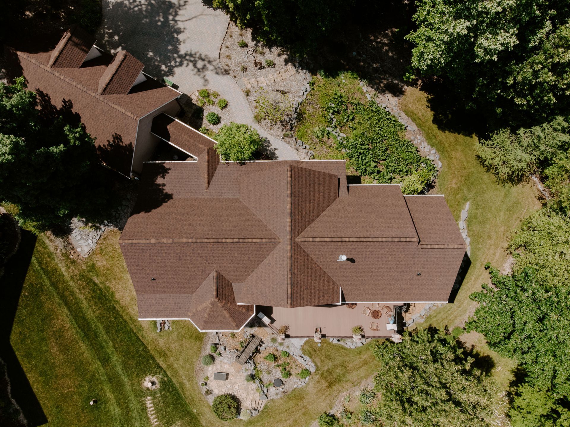 An aerial view of a large house surrounded by trees