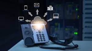 Cloud-based phone system. A desk phone with arrows connecting to a cloud, symbolizing devices connecting to a cloud network.