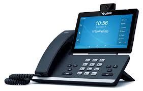 A black Yealink video phone with a touchscreen display, keypad, handset, and attached camera.