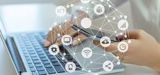 Person using laptop and smartphone with connected icons overlaid, representing digital communication.