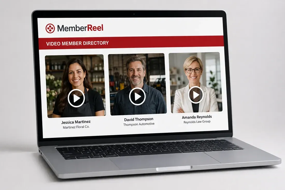Laptop showing the white and red MemberReel directory with three member video thumbnails and play buttons