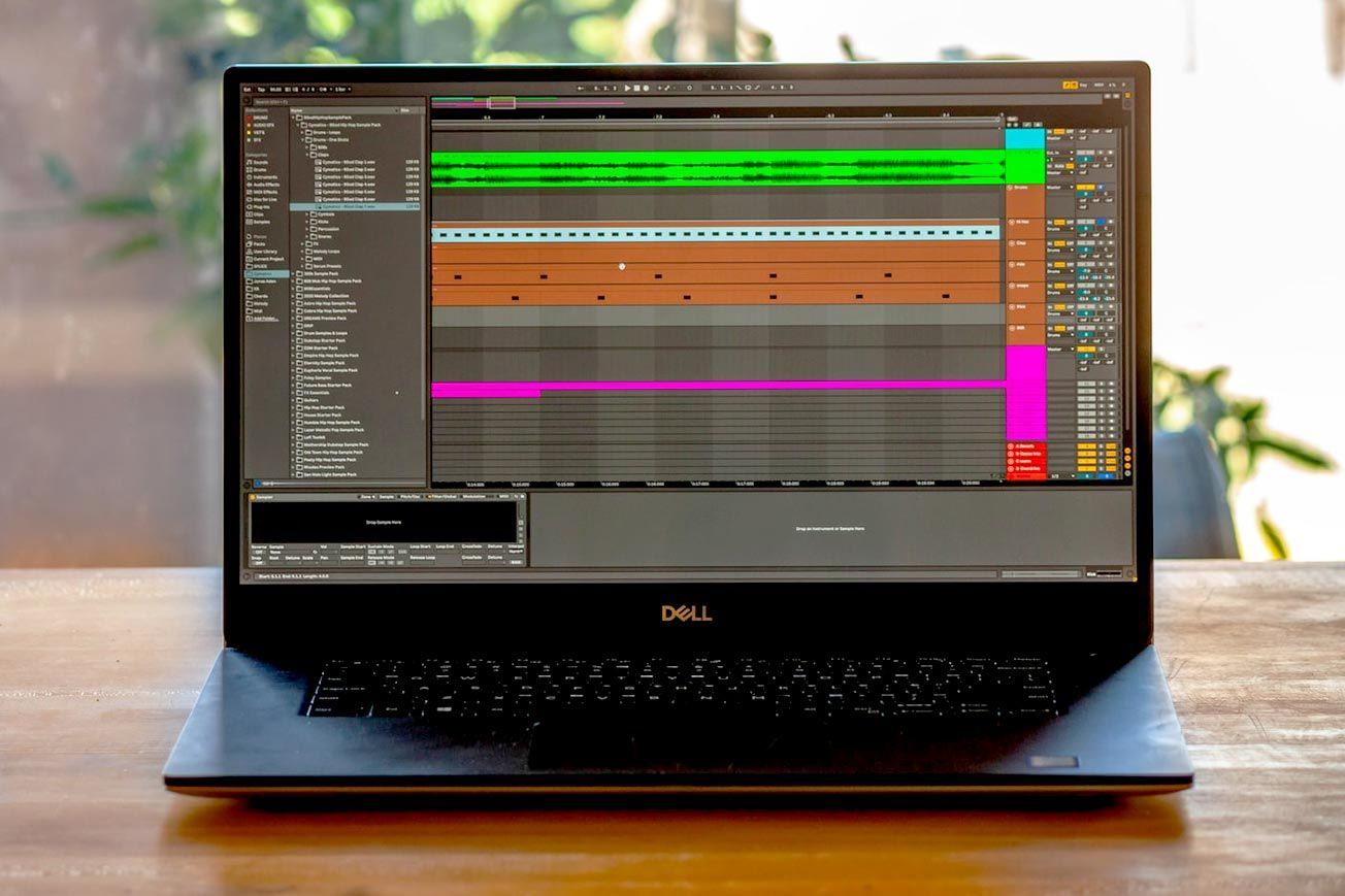 A dell laptop is open on a wooden table