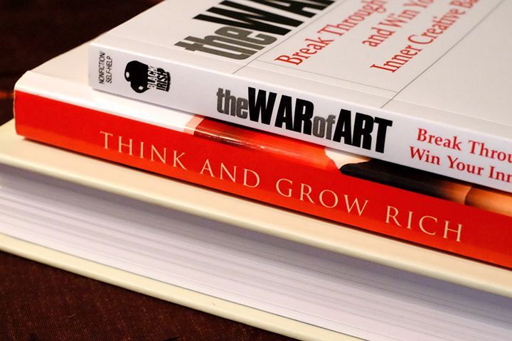 A stack of books with one titled think and grow rich