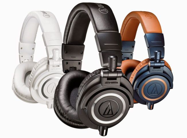 Three different colored headphones are sitting next to each other on a white background