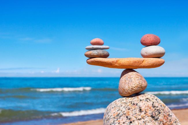 A pile of rocks stacked on top of each other on a beach.