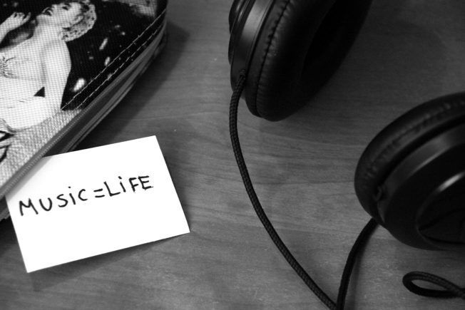A note that says music life next to a pair of headphones