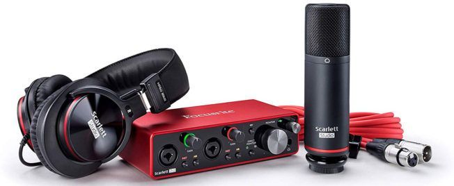 A pair of headphones and a microphone are sitting next to each other on a table.