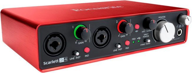 A red and black audio interface with a lot of buttons and knobs.