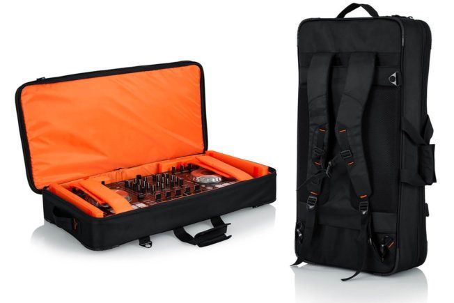 A black bag with an orange lining is sitting on a white surface.
