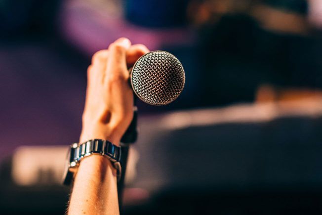A person is holding a microphone in their hand.