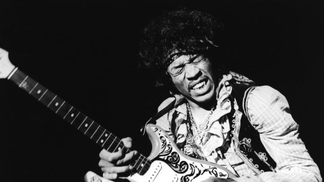 A black and white photo of a man playing a guitar