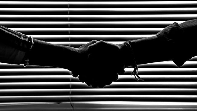 Monochrome Photo of People Shaking Hands