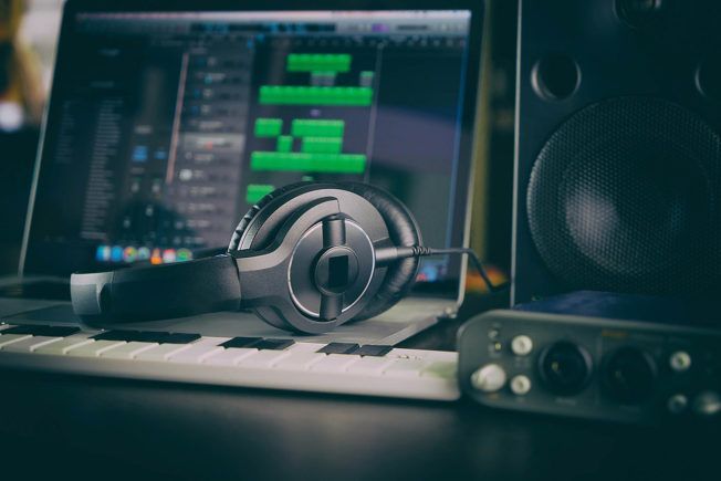 A pair of headphones sitting on top of a laptop keyboard.