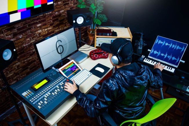 A man is sitting at a desk in front of a computer.