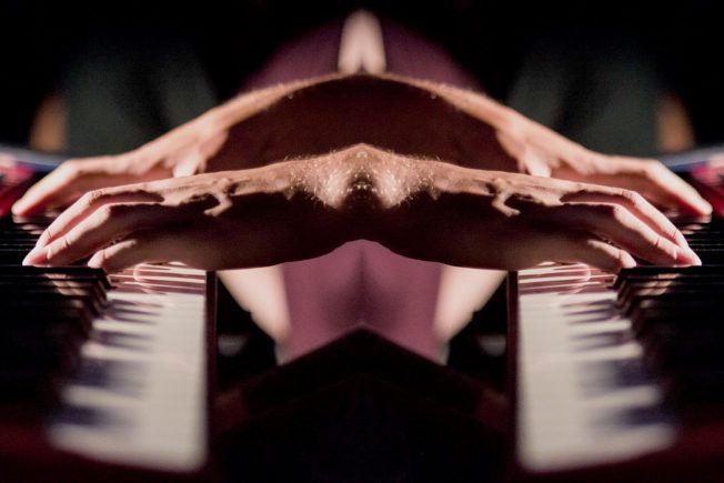 A close up of a person playing a piano