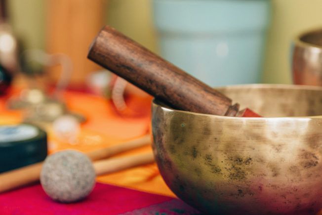 A bowl with a wooden stick in it is on a table.