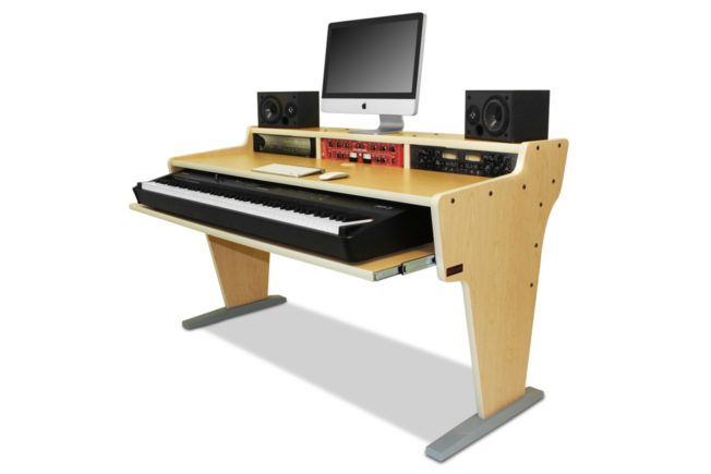 A wooden desk with a keyboard and a computer on it