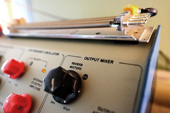 A close up of an output mixer with red knobs