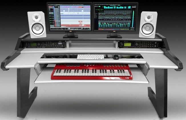 A desk with two monitors and a keyboard on it