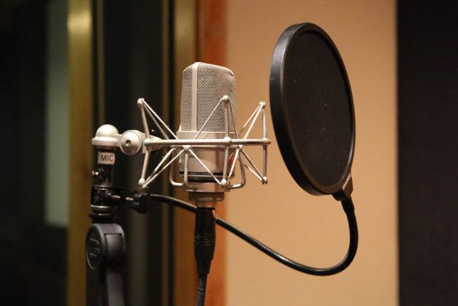 A microphone with a pop filter attached to it
