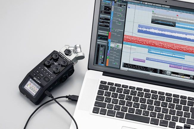 A recording device is plugged into a laptop computer.
