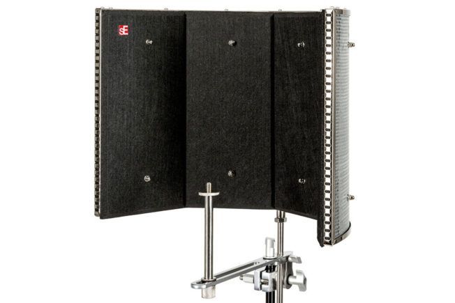 A black shield is sitting on a stand on a white background