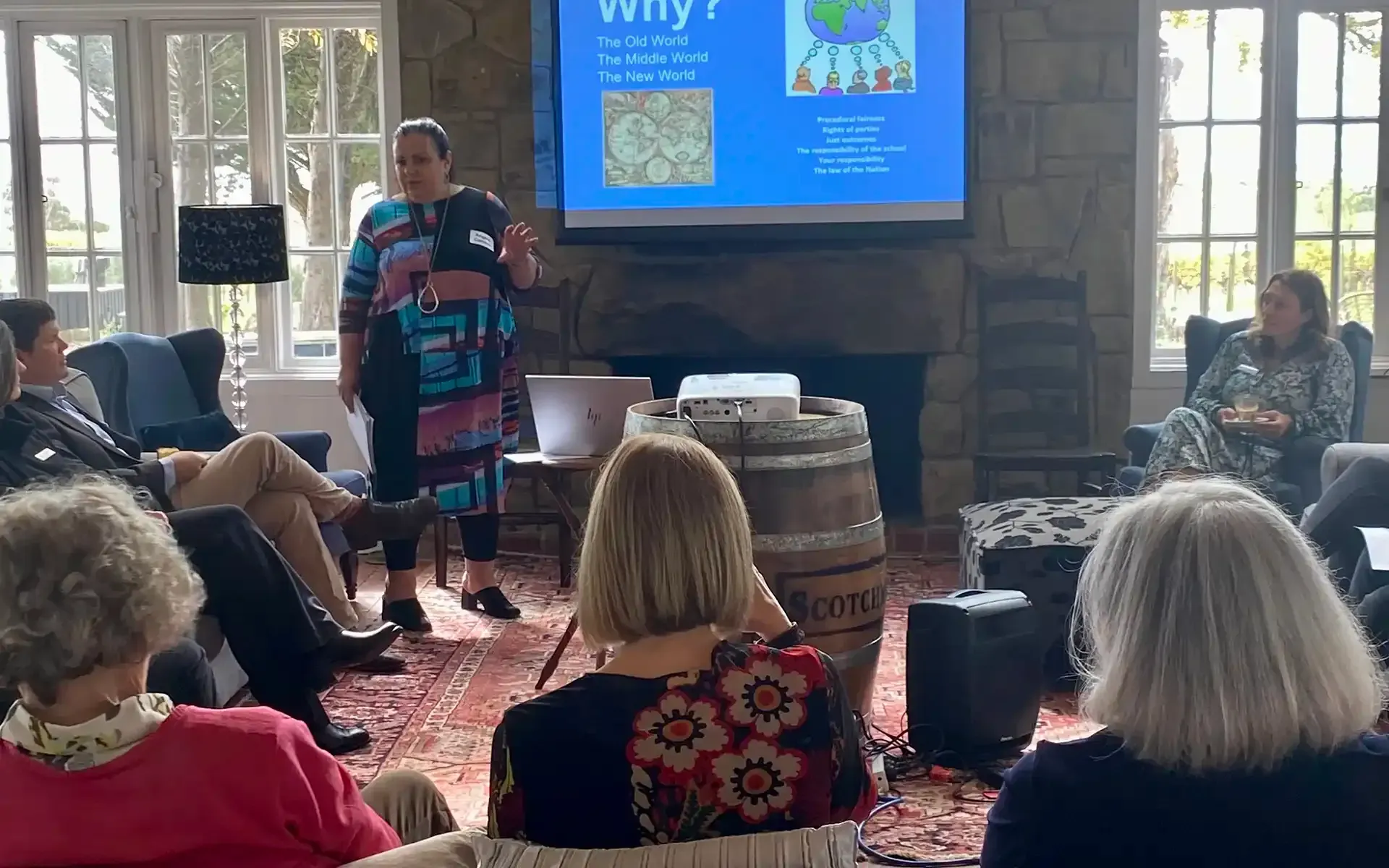 A group of people watching a presentation from Angela Cannon at the Healing & Hope Mothers' Retreat.