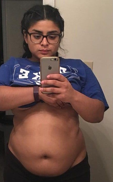 A woman is taking a picture of herself in the mirror.
