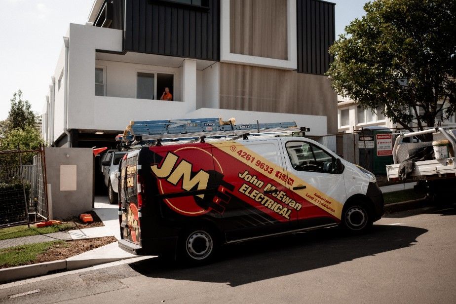 A JME Electrical Van is Parked in Front of a House — John McEwan Electrical In Dapto, NSW
