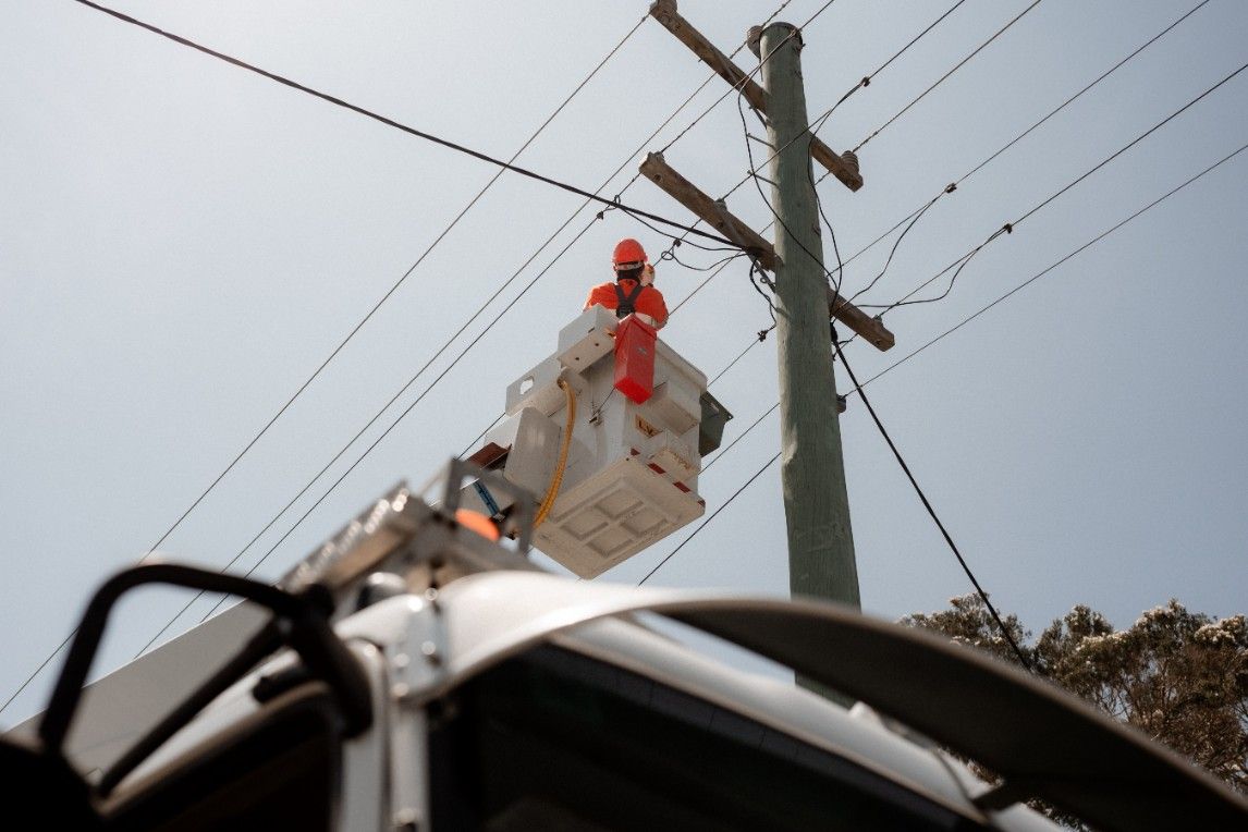 An Electrician is Working on a Power Pole — John McEwan Electrical In Dapto, NSW