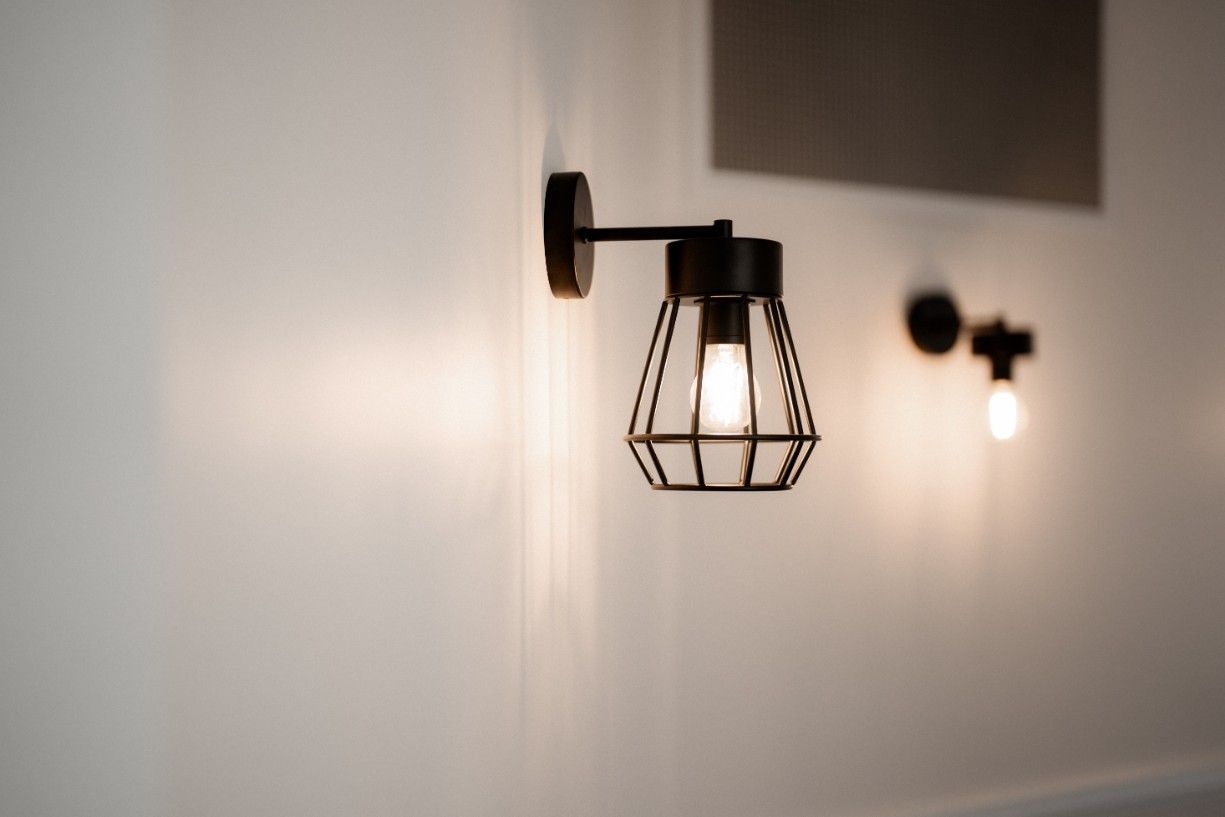 A Light Fixture is Hanging on a White Wall — John McEwan Electrical in Dapto, NSW