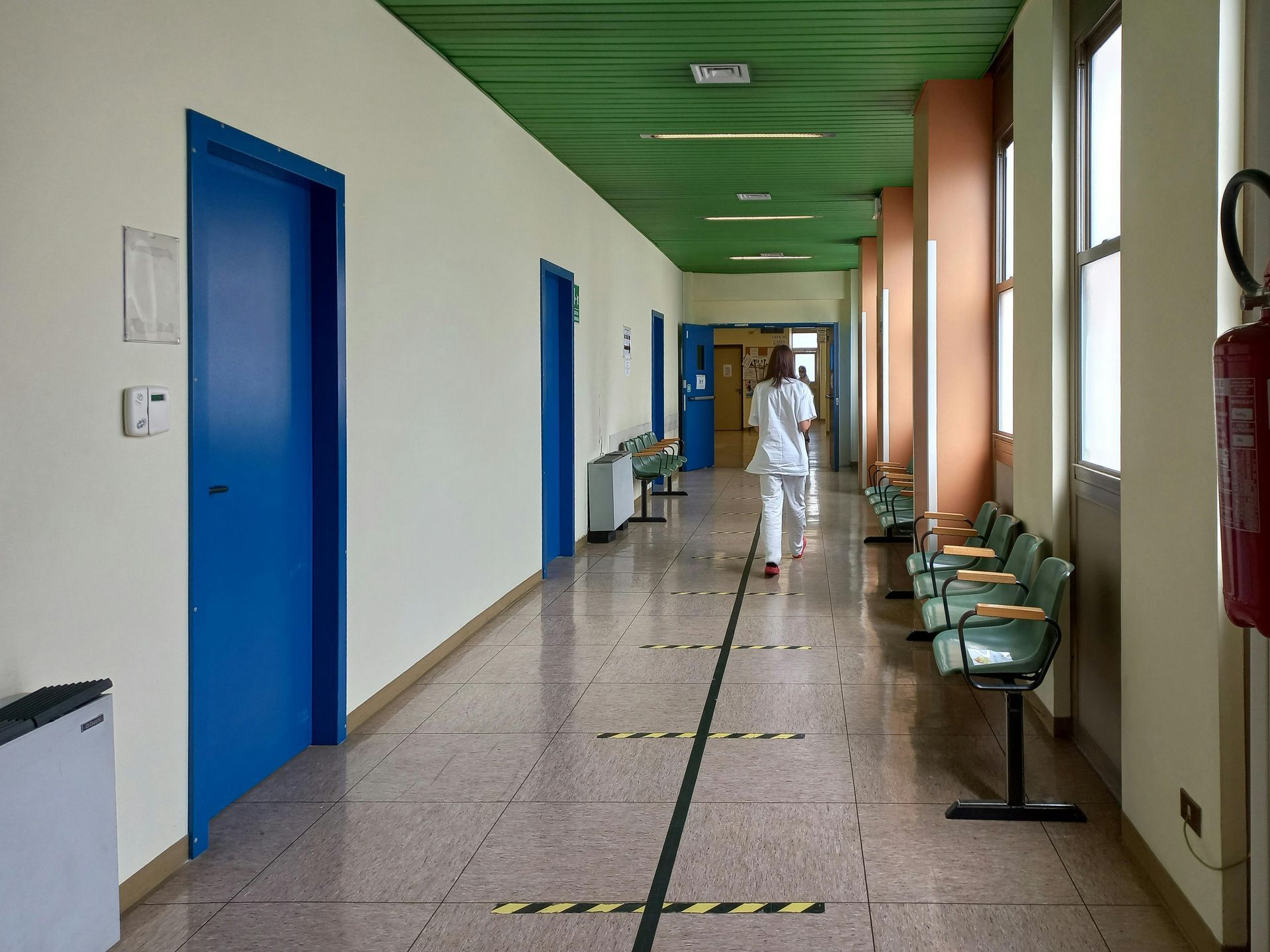 A nurse is walking down a hospital hallway