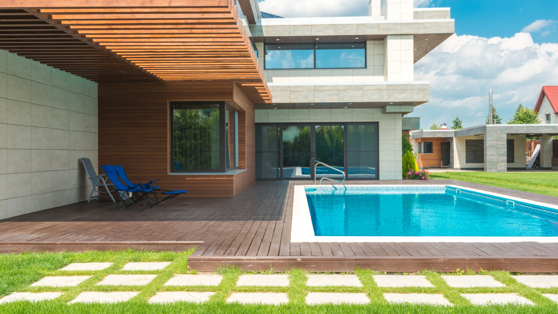 A close up of a swimming pool with blue tiles and stairs.