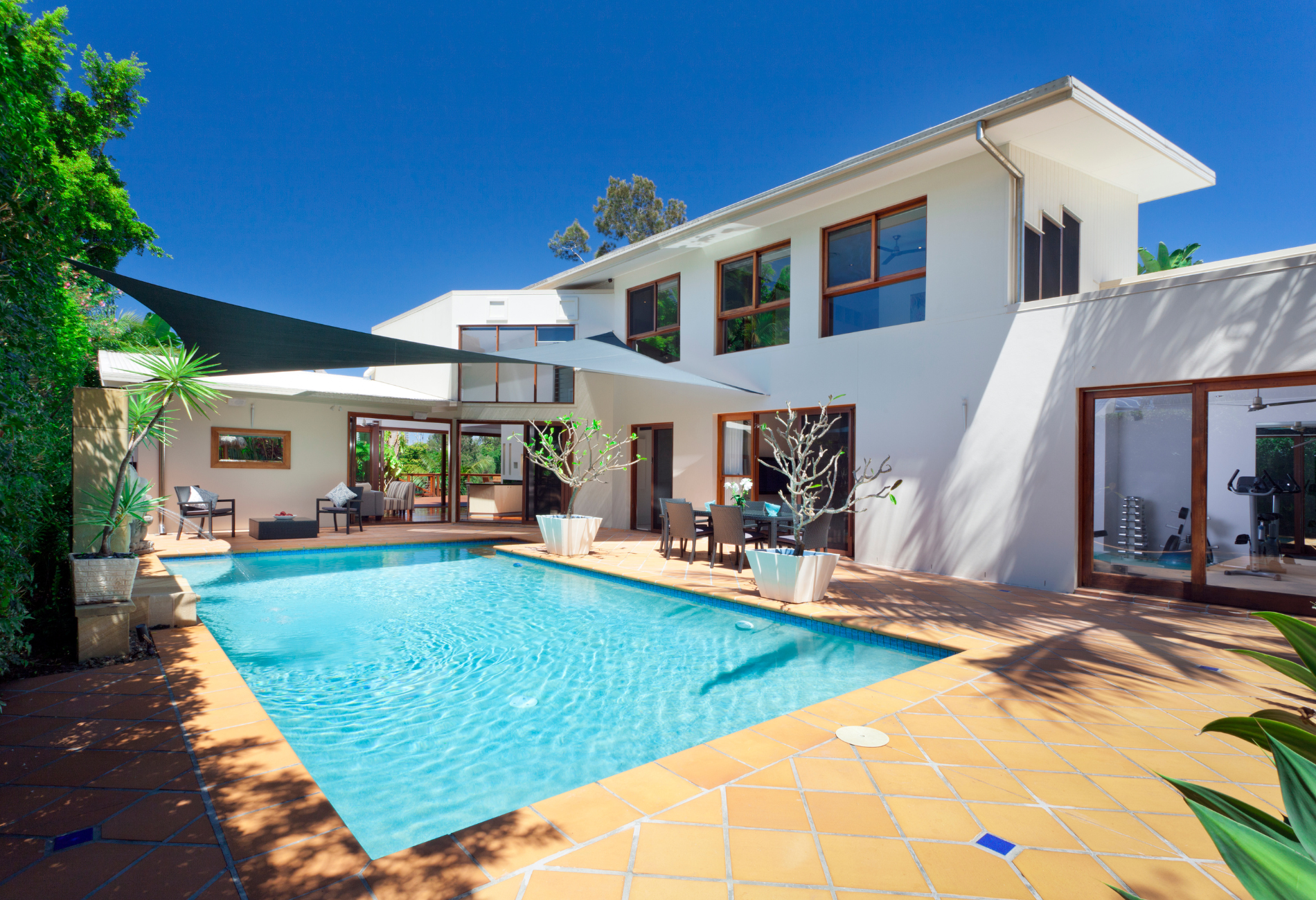 A large white house with a swimming pool in front of it