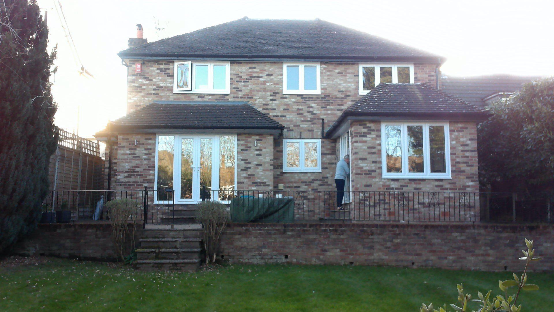 A large brick house with a lawn in front of it
