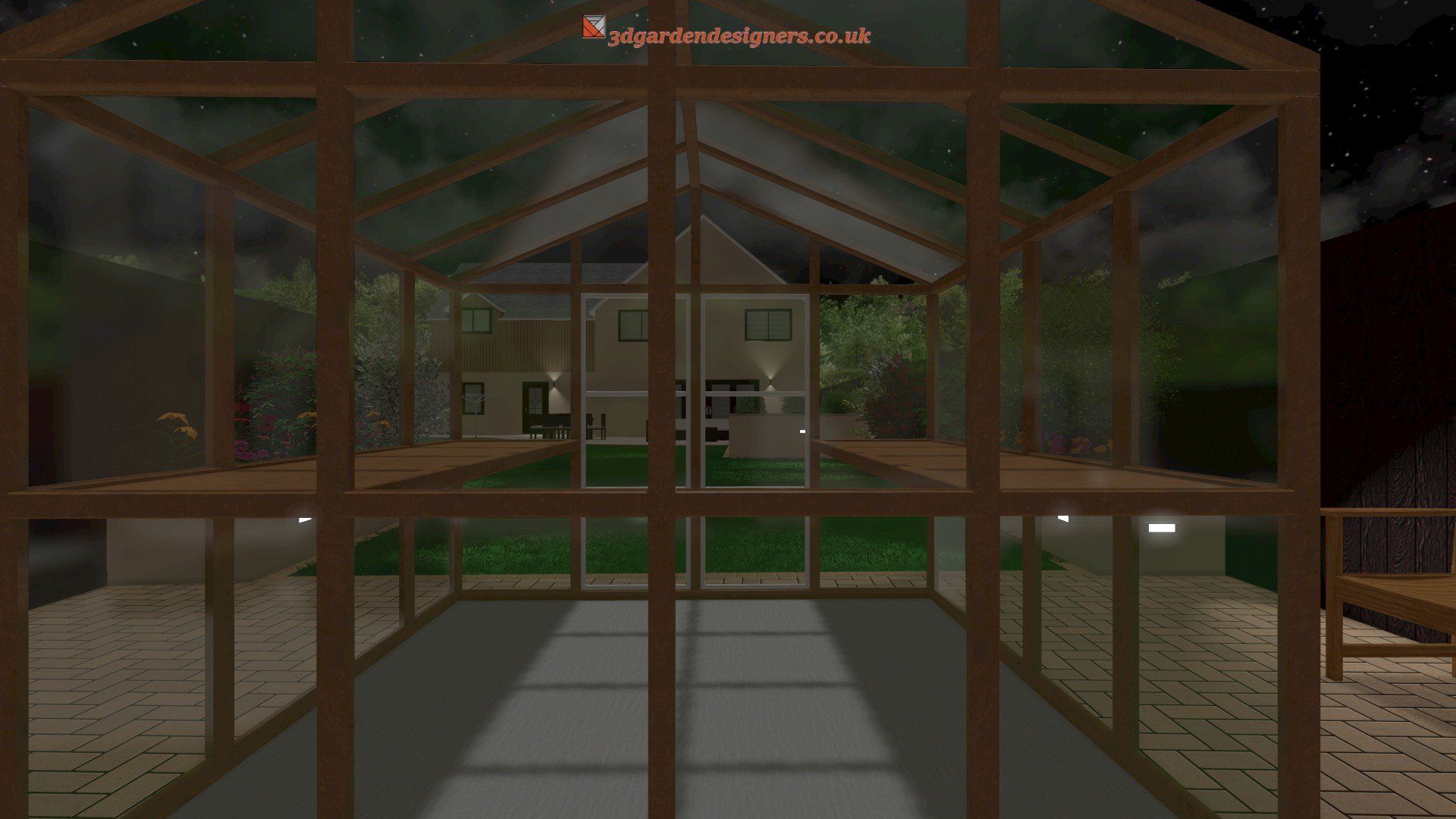 A greenhouse with a house in the background at night.