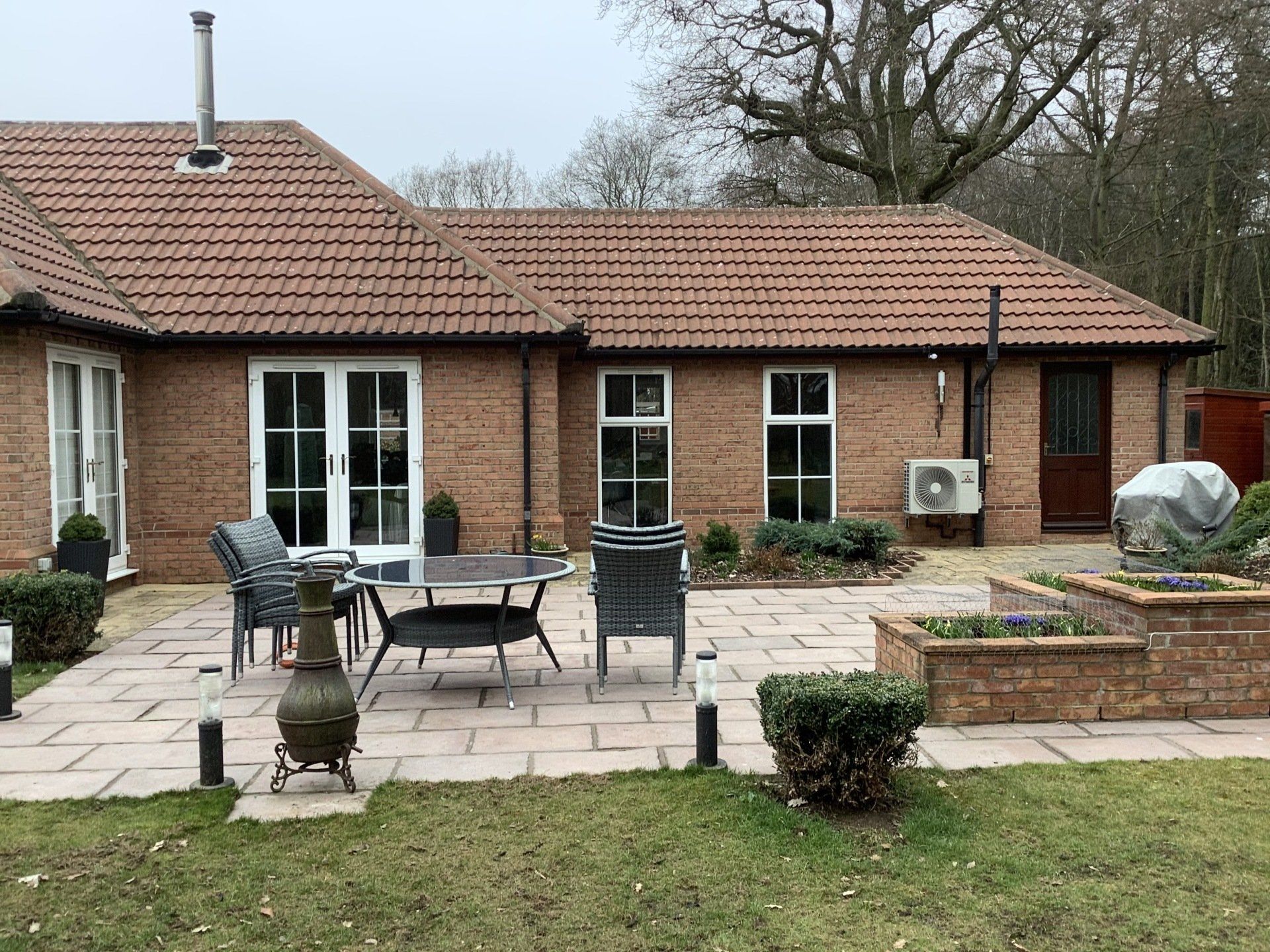 before A brick house with a patio in front of it