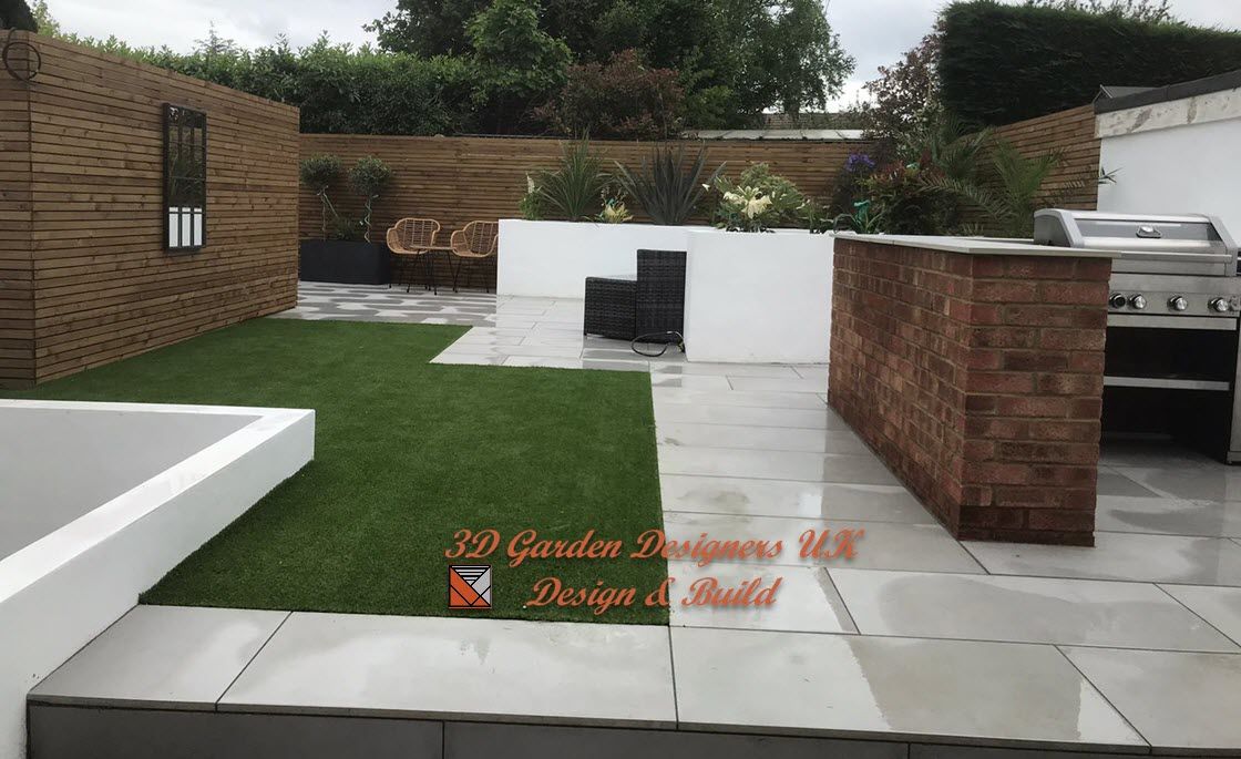 A garden with a brick wall and a grill
