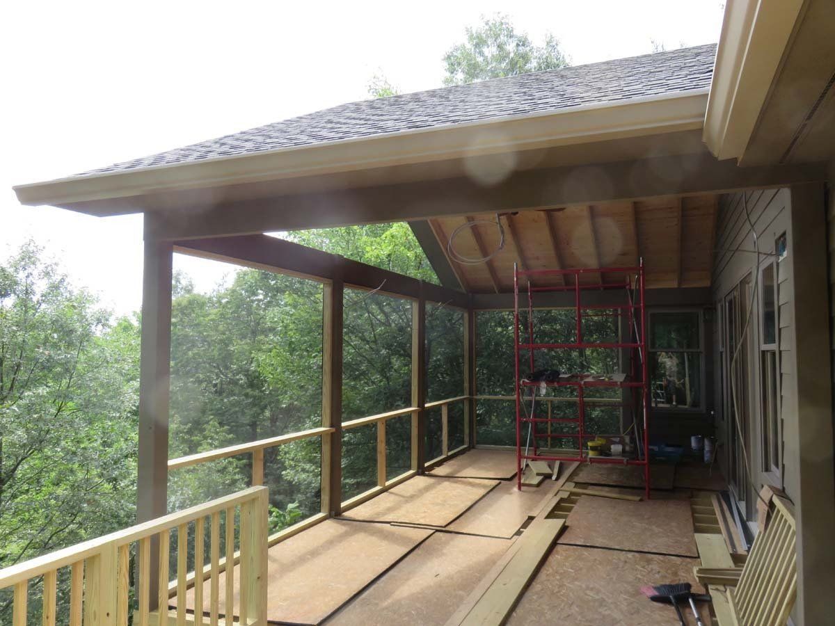 A screened-in porch is being built on the side of a house in Asheville, NC.
