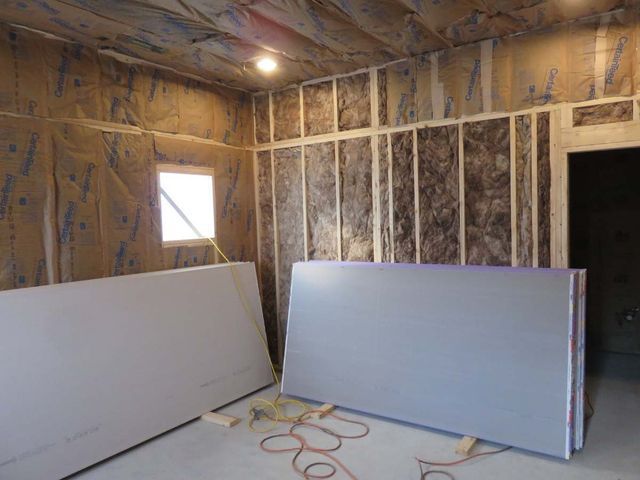 A renovation room with dry wall waiting to be installed leaning against it in Asheville, NC.