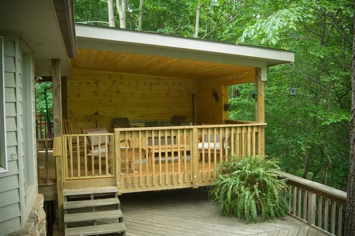 a custom exterior home addition that shows a wooden covered porch in Asheville, NC.