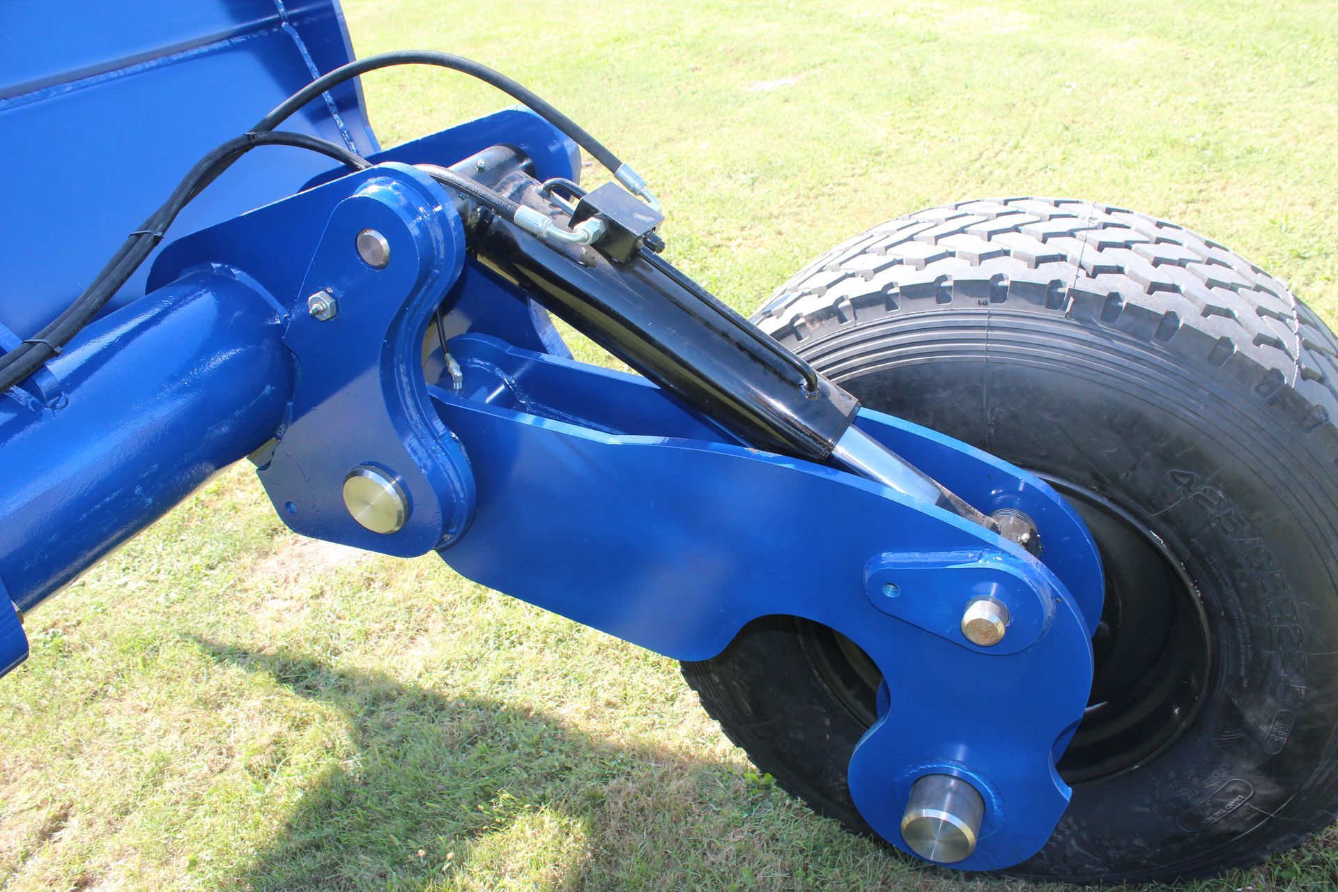 A close up of a wheel on a blue scraper 